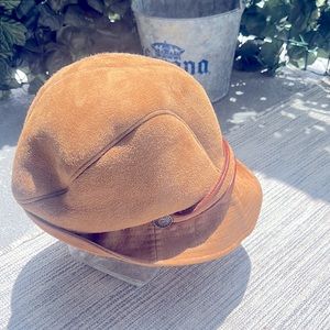 Ugg Tan Shearling sheepskin with brown leather trim.